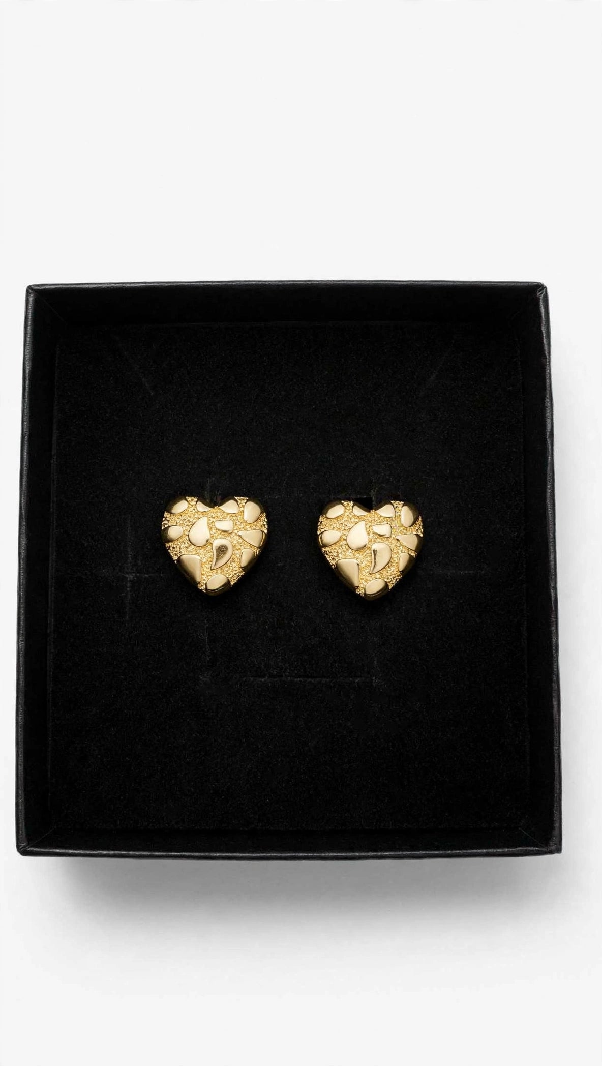 Gold nugget textured heart stud earrings presented in a black gift box
