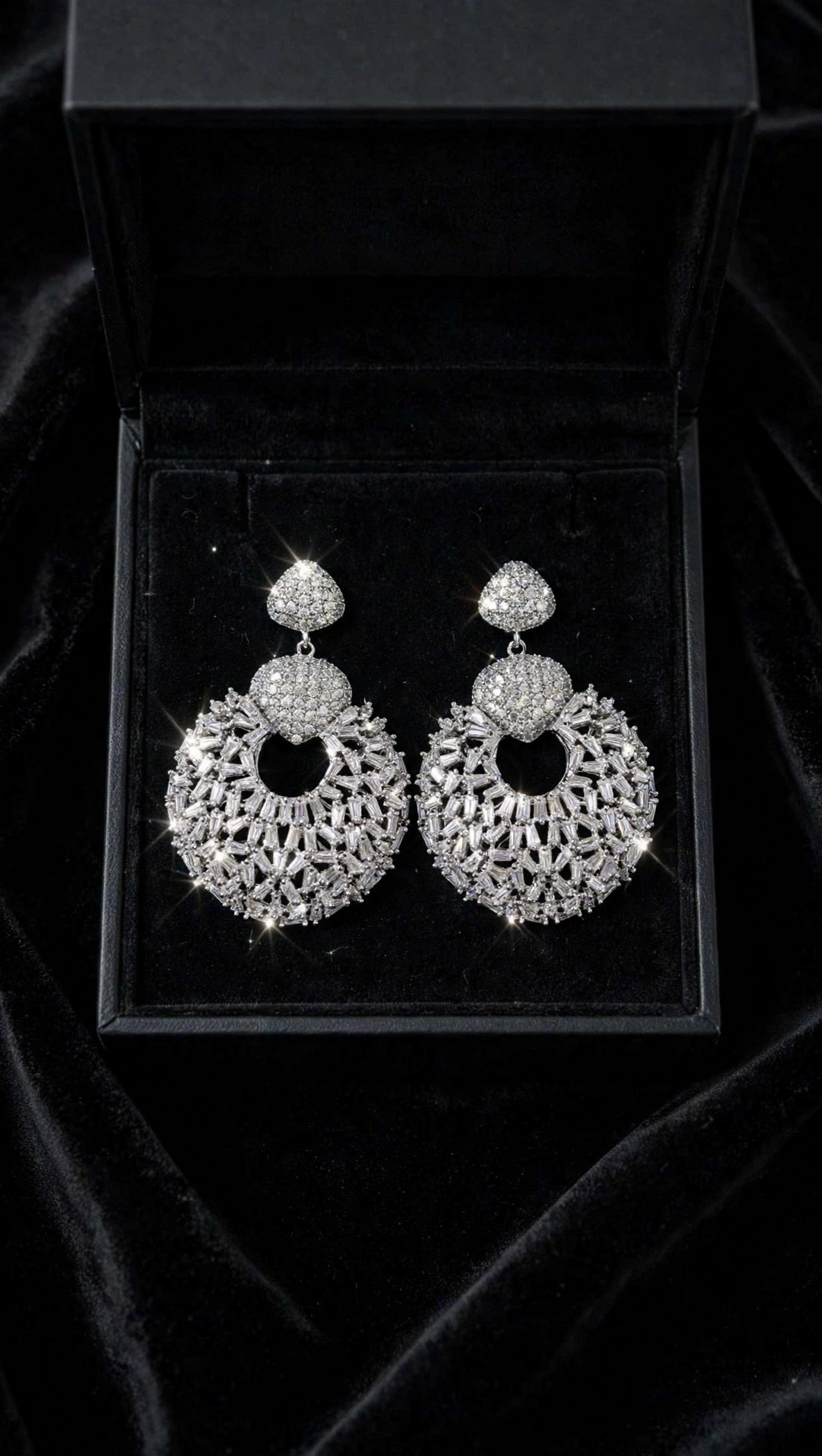 Pair of silver cubic zirconia halo drop earrings in a black velvet gift box
